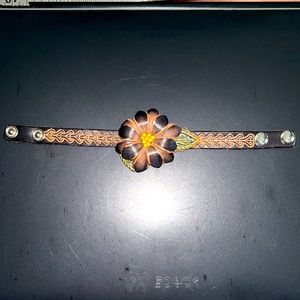 Floral leather snap bracelet.